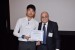 Dr. Nagib Callaos, General Chair, giving Mr. Seulbae Kim the best paper award certificate of the session "Computer Science and Engineering II." The title of the awarded paper is "SIGMATA: Storage Integrity Guaranteeing Mechanism against Tampering Attempts for Video Event Data Recorders."